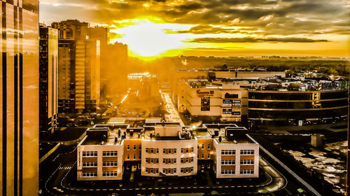 High angle view of buildings in city against sky during sunset