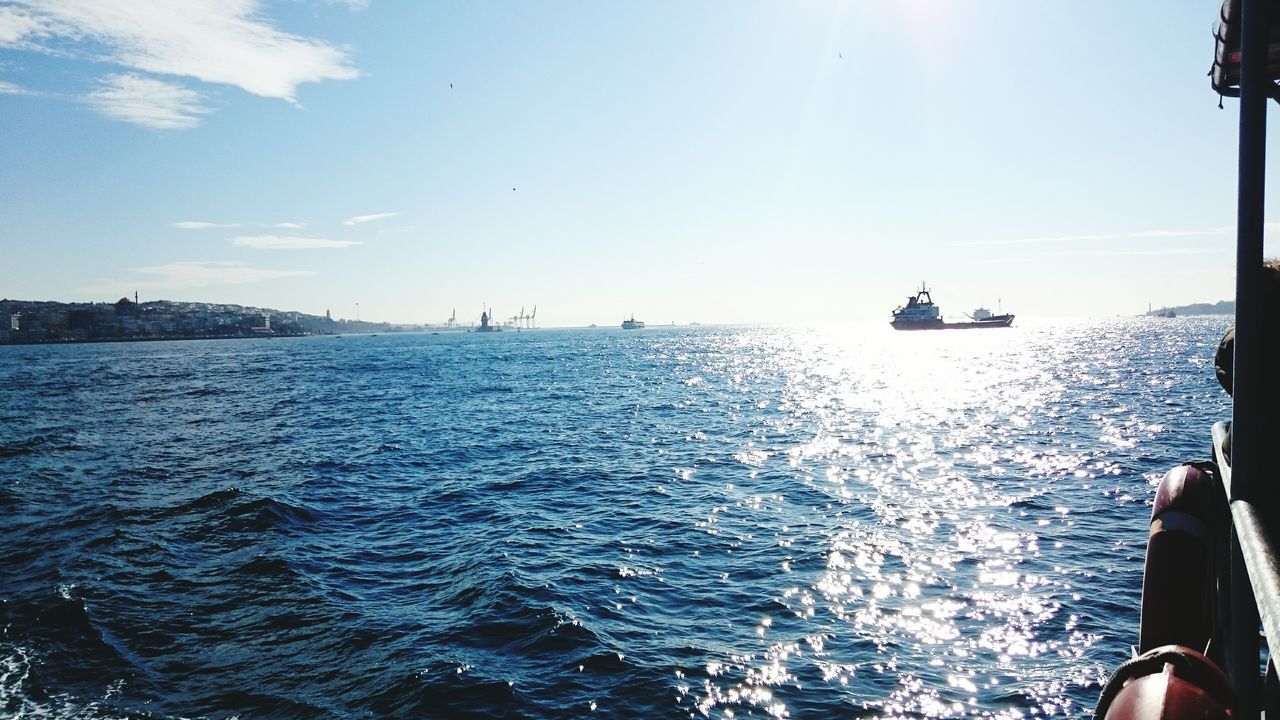 water, sea, nautical vessel, lifestyles, transportation, leisure activity, men, mode of transport, blue, boat, waterfront, rippled, scenics, nature, sky, travel, sailing, beauty in nature