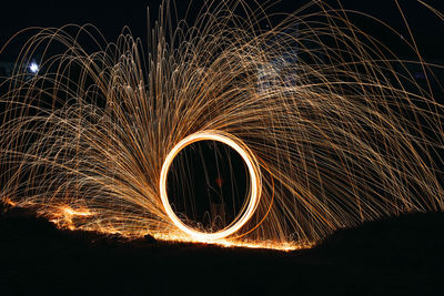 Wire wool against sky at night