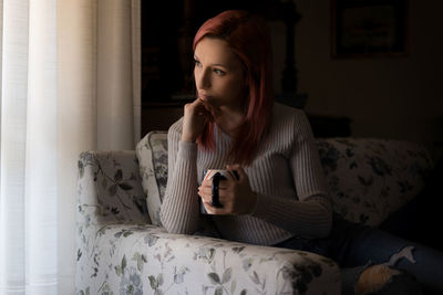 Young woman looking at camera at home