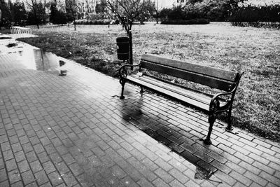 Empty bench by footpath in park