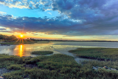 Scenic view of land against sky during sunset