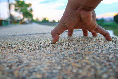 Close-up of person hand on street
