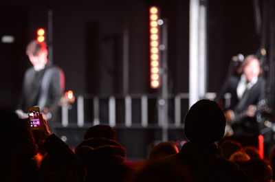 Rear view of people at illuminated nightclub