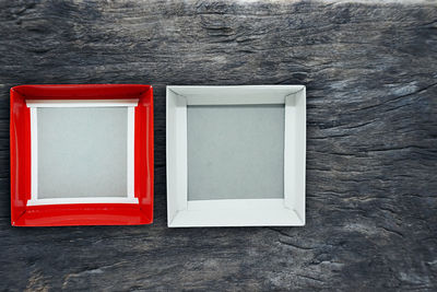 High angle view of red paint on table against wall