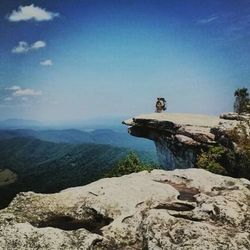 View of statue on rock against blue sky