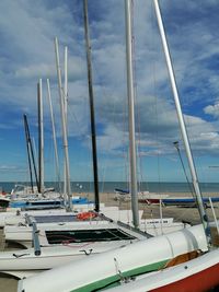 Sailboats moored in harbor