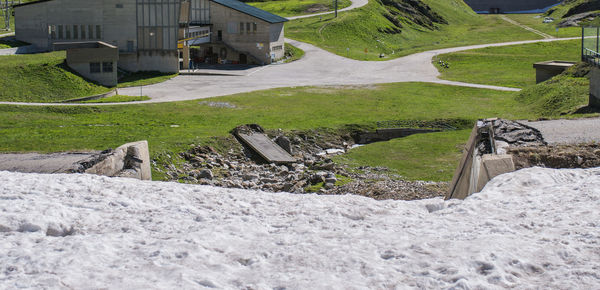 Scenic view of field by buildings in city