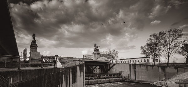 View of cityscape against cloudy sky