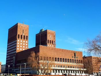 Low angle view of buildings against blue sky