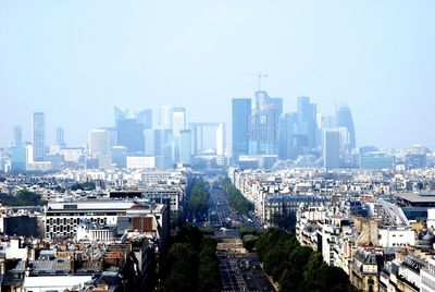 Aerial view of modern buildings in city against clear sky