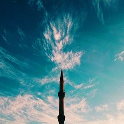 Low angle view of tower against cloudy sky