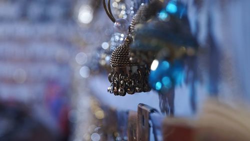 Close-up of necklace hanging outdoors