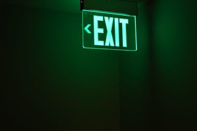 Close-up of illuminated sign on wall