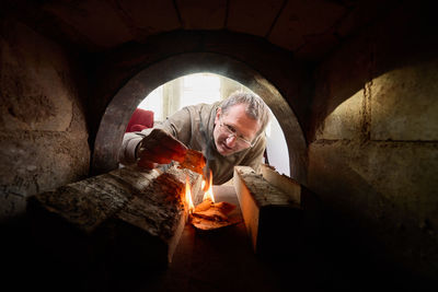 Low angle view of man standing in tunnel
