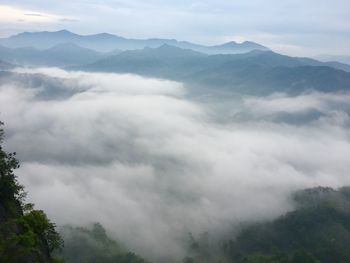 Scenic view of mountains against cloudy sky