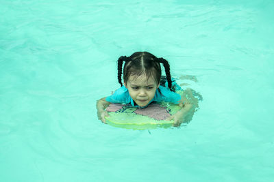 High angle view of girl swimming in pool