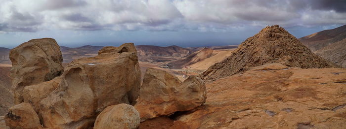 Panoramic view of landscape against cloudy sky