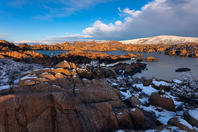A winter storm clears over watson lake at sunset in prescott, arizona.
