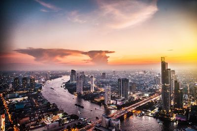 Aerial view of city against cloudy sky