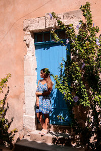 Woman standing by building wall in provence 