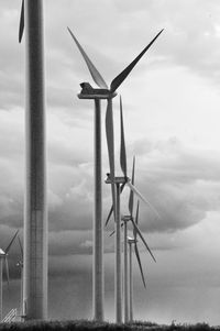 Windmill on field against sky
