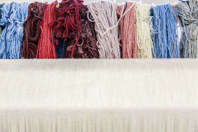 Low angle view of multi colored strings in textile industry