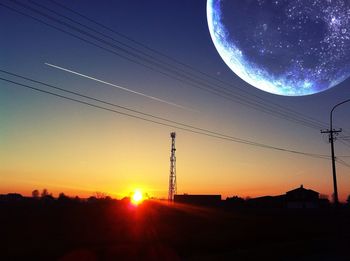 Low angle view of electricity pylon against sky