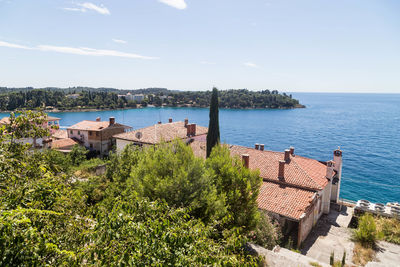 High angle view of buildings by sea against sky