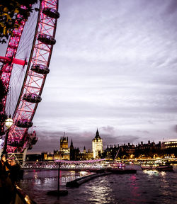 View of illuminated city at riverbank