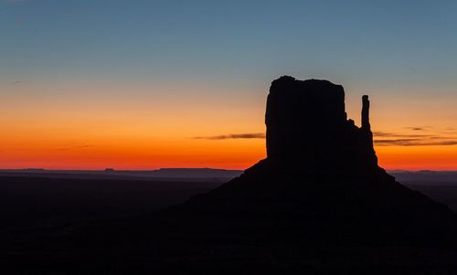 Silhouette landscape against sky during sunset