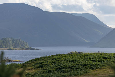 Scenic view of lake and mountains against sky