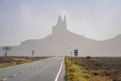 Signboards by highway leading towards geological features in monument valley