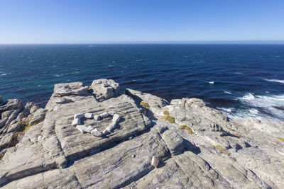 View from the top of the hill at cape of good hope point to atlantic ocean, heart shaped stones.