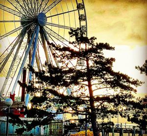 Low angle view of ferris wheel against sky