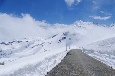 Scenic view of snow covered mountains against sky