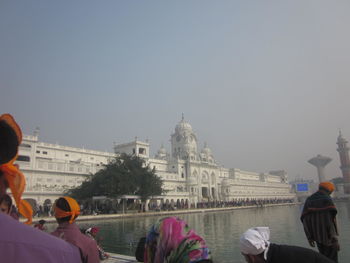 People in city against clear sky