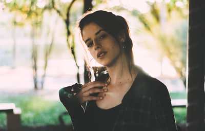 Portrait of young woman standing outdoors