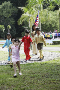 Rear view of people enjoying in park