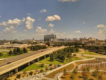 High angle view of road by buildings against sky