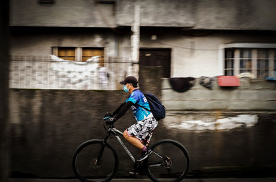 Man riding bicycle on building