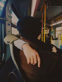 Close-up of couple sitting with arm around sitting in bus