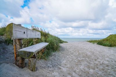 Lifeguard hut on beach against sky