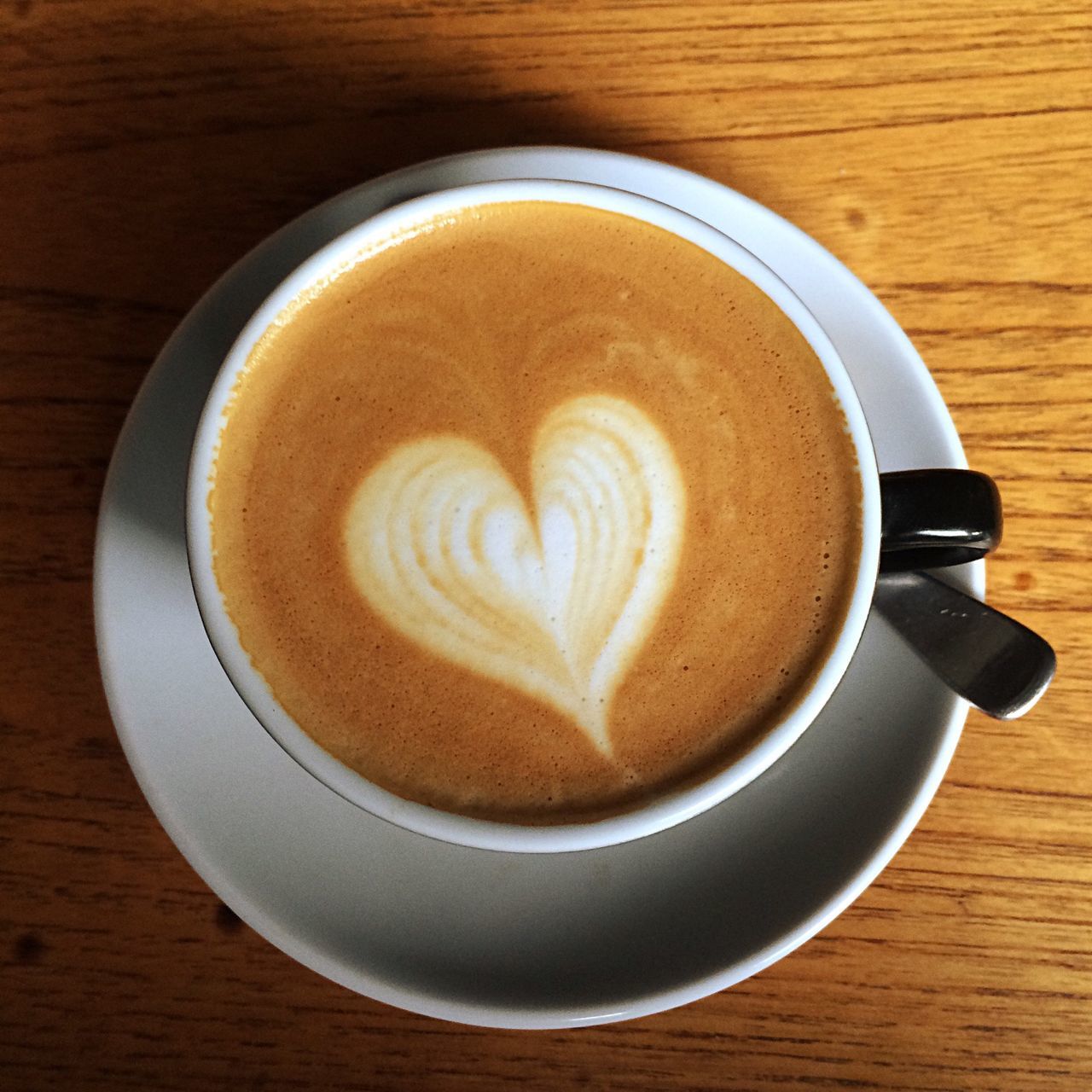 coffee cup, food and drink, refreshment, drink, coffee - drink, saucer, indoors, cappuccino, table, freshness, frothy drink, froth art, coffee, still life, directly above, cup, high angle view, heart shape, creativity, art