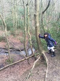 Man standing on footpath in forest