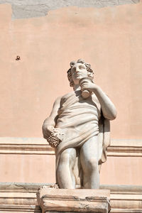 Low angle view of statue against building