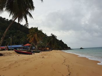 View of beach against cloudy sky