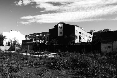 Houses against cloudy sky