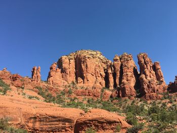 Rock formations against clear blue sky