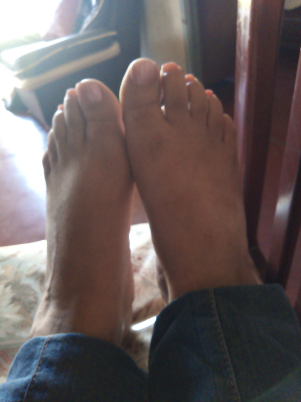 human leg, barefoot, low section, human foot, relaxation, limb, indoors, adult, toe, one person, finger, lifestyles, hand, human limb, men, personal perspective, resting, sole of foot, arm, leisure activity, women, day, furniture, close-up, home interior, person, jeans, sitting